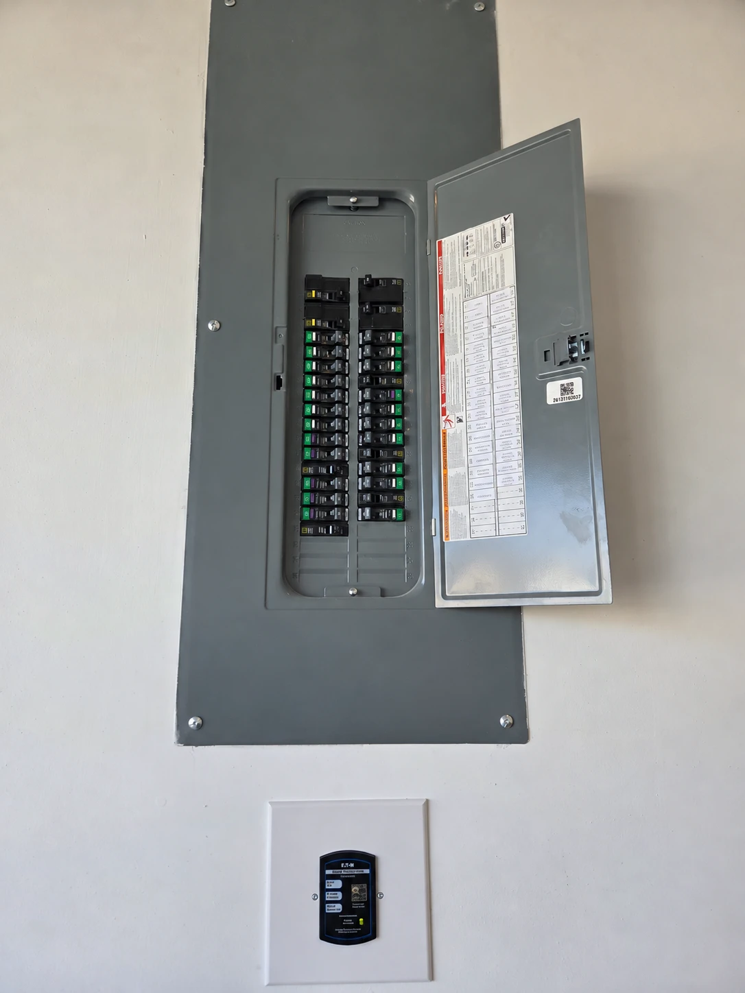 Whole home surge protector installed below a residential panel